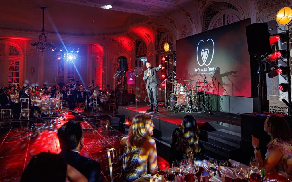 Speaker addressing the audience at a charity gala dinner